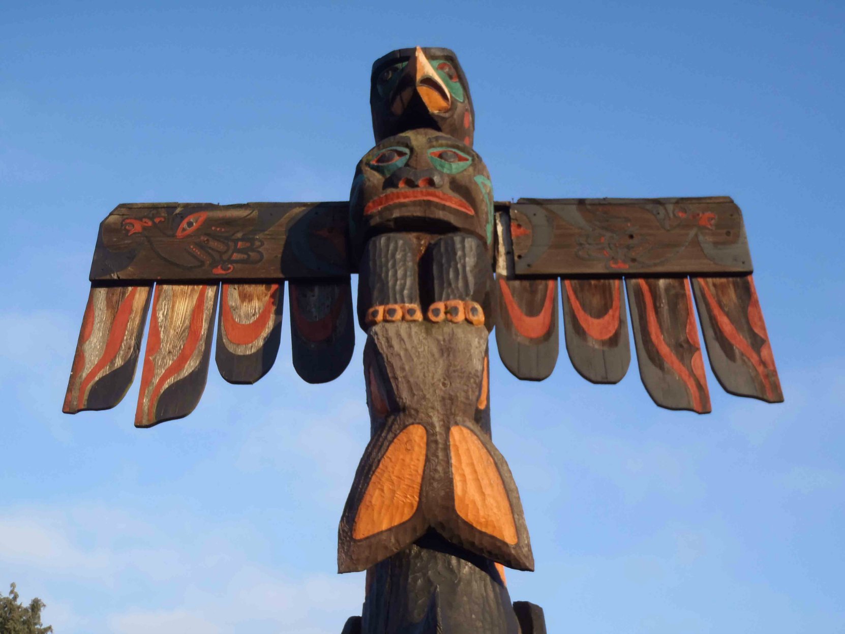 Pole of Wealth, Thunderbird figure. Canada Avenue at Kenneth Street