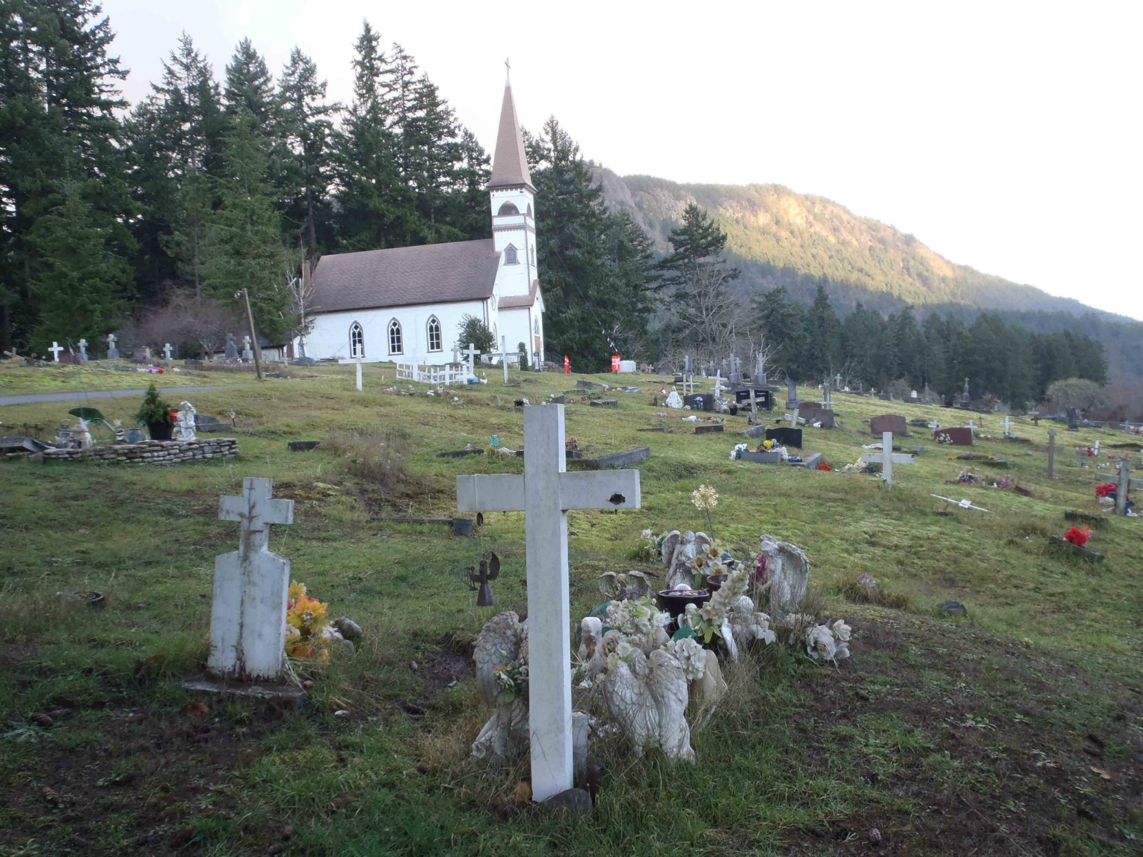 Simon Charlie's grave, with St. Ann's Catholic Church and Mt. Tzouhalem in the background.