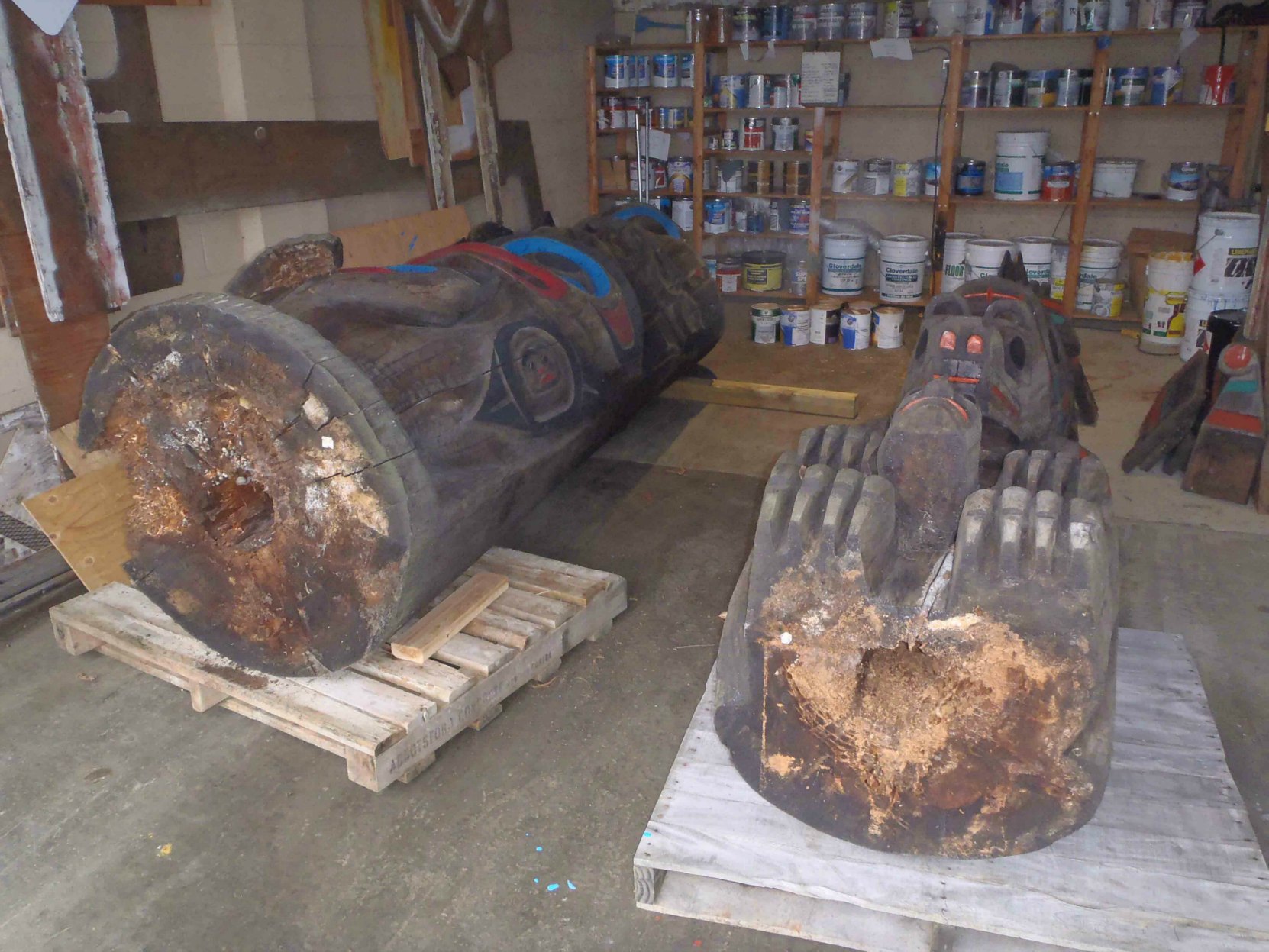 The Feast and Pole of Wealth totem poles during restoration and maintenance, 2016