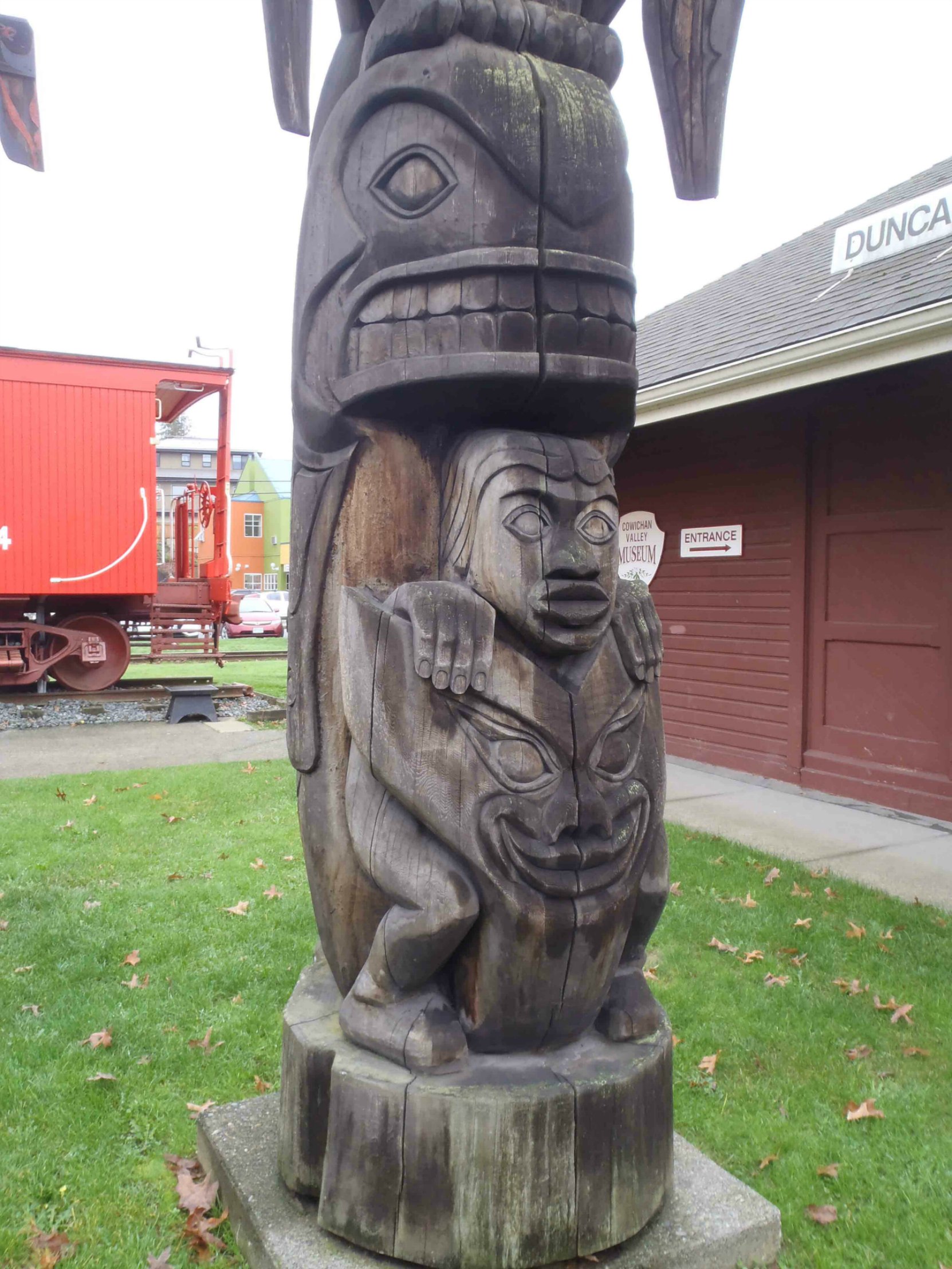 Transformation totem pole, Killer Whale, Man and Wolf figures - Canada Avenue, Duncan