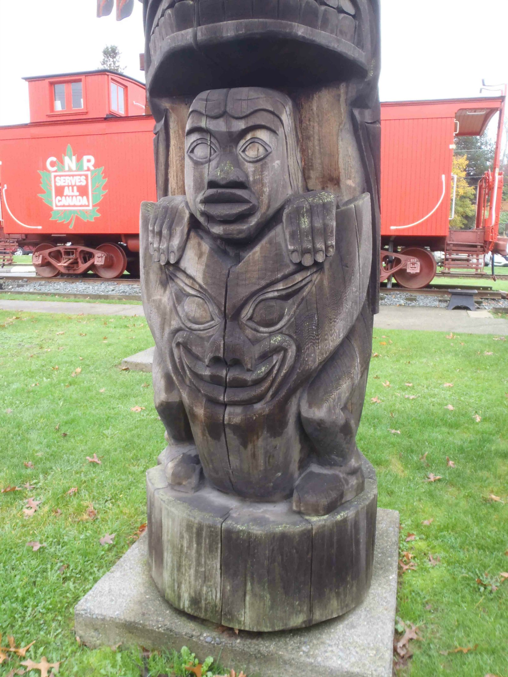 Transformation totem pole - Man and Wolf figure detail - Canada Avenue, Duncan