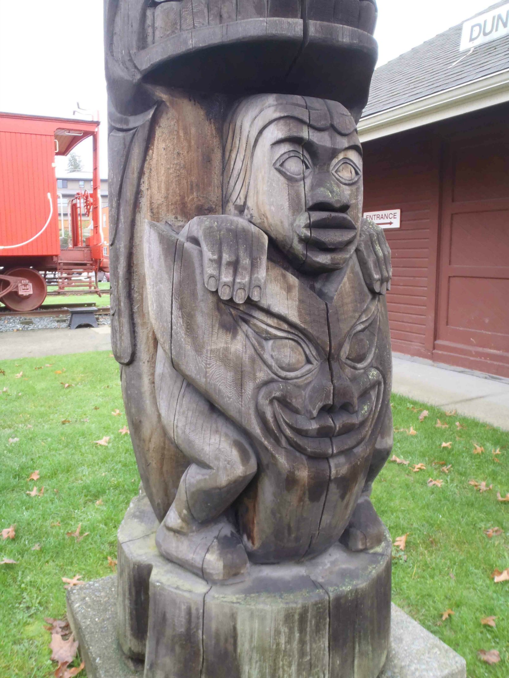 Transformation totem pole - Man and Wolf figure detail - Canada Avenue, Duncan